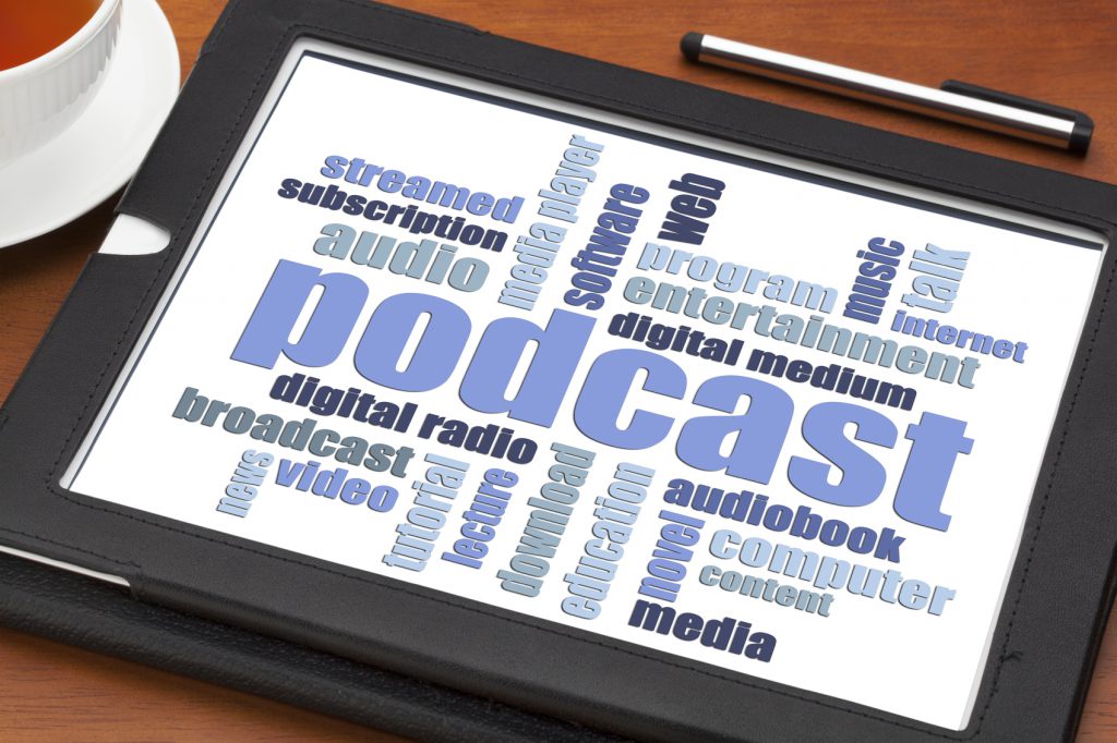 podcast word cloud on a digital tablet with a cup of coffee - internet radio concept